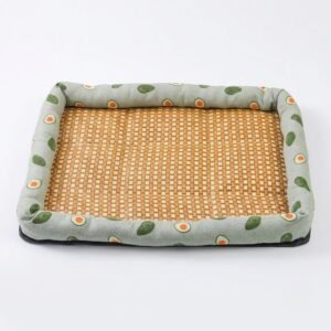 PetzVibes Natural Rattan Cooling Pet Bed Mat for dogs and cats in Avocado Print design &mdash; studio product photo showing natural golden-honey woven rattan center and padded sage green Oxford fabric border