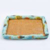 PetzVibes Breathable Rattan Pet Cooling Mat for cats and dogs in Tropical Fish Print — studio product photo showing natural golden-honey woven rattan center and padded aqua Oxford fabric border with cartoon fish pattern