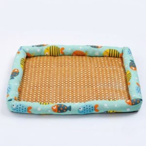 PetzVibes Breathable Rattan Pet Cooling Mat for cats and dogs in Tropical Fish Print &mdash; studio product photo showing natural golden-honey woven rattan center and padded aqua Oxford fabric border with cartoon fish pattern