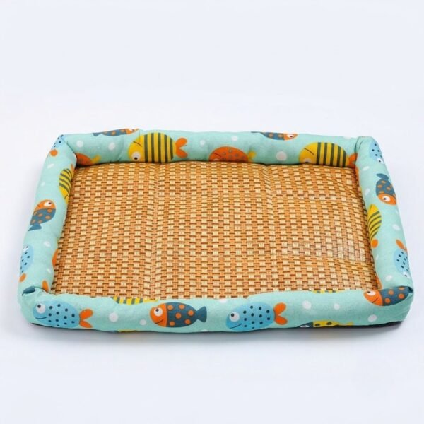 PetzVibes Breathable Rattan Pet Cooling Mat for cats and dogs in Tropical Fish Print — studio product photo showing natural golden-honey woven rattan center and padded aqua Oxford fabric border with cartoon fish pattern
