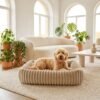 plush-ribbed-calming-pet-bed-cats-dogs-beige-golden-doodle-californian-modern-living-room.jpg Golden Doodle sitting happily in a PetzVibes beige plush ribbed calming pet bed on a cream boucle rug in a bright Californian modern living room