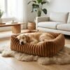 plush-ribbed-calming-pet-bed-cats-dogs-brown-golden-retriever-scandinavian-living-room.jpg Golden Retriever sleeping in a PetzVibes brown plush ribbed calming pet bed placed on a sheepskin rug in a bright Scandinavian living room