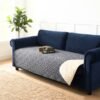 Cat sleeping on a Grey Anti-Leakage Waterproof Dog Bed Cover draped over a navy velvet sofa