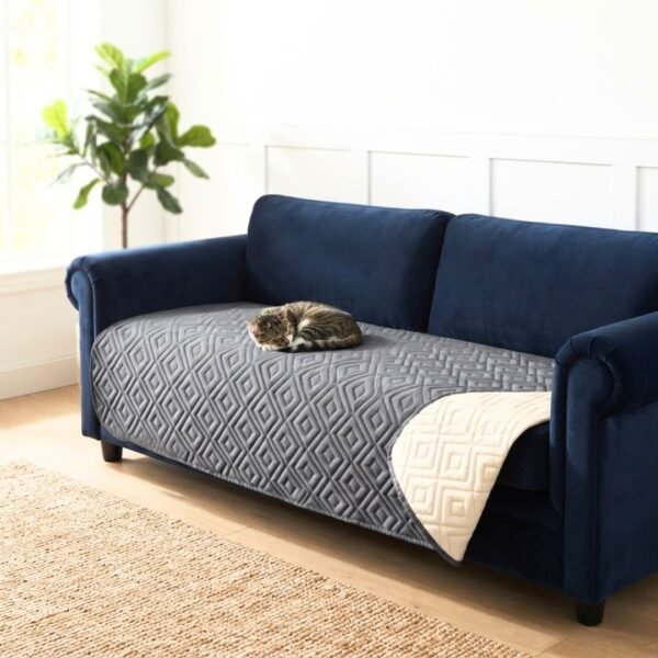 Cat sleeping on a Grey Anti-Leakage Waterproof Dog Bed Cover draped over a navy velvet sofa